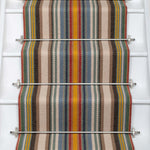 Striped flatweave runner in sage yellow red and blue on white staircase