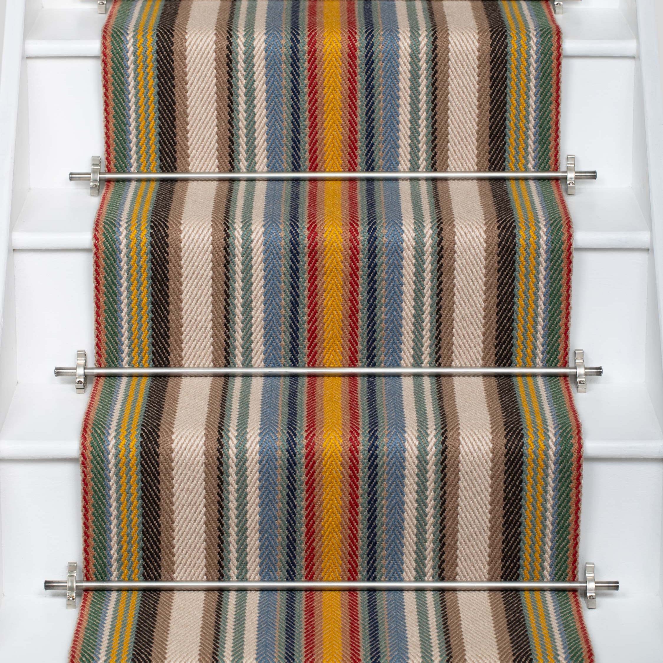 Striped flatweave runner in sage yellow red and blue on white staircase