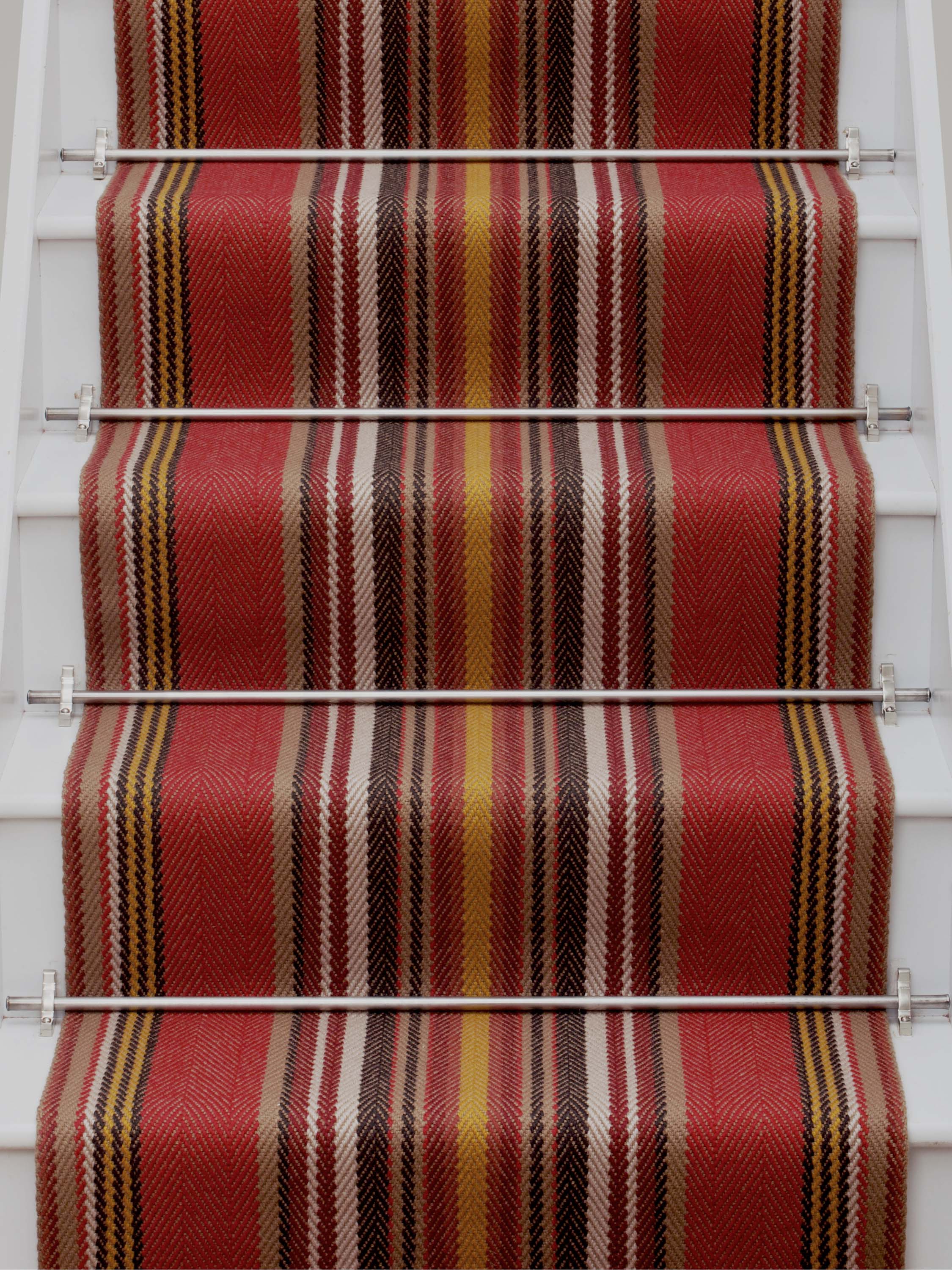 Striped flatweave runner in red yellow white and black on white staircase