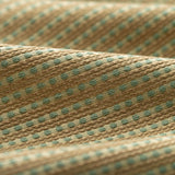 Lightly folded fabric with green dots and tan stripes on a white background