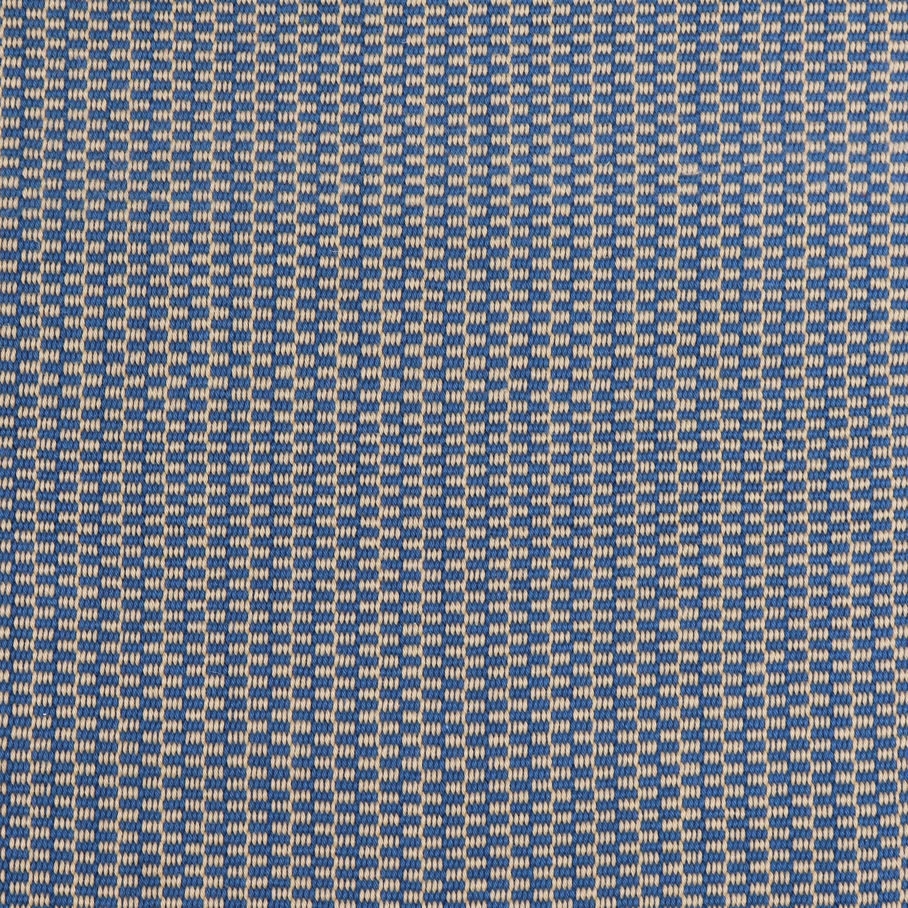 Detail of a hand-woven cotton fabric in a grid pattern in blue and tan.