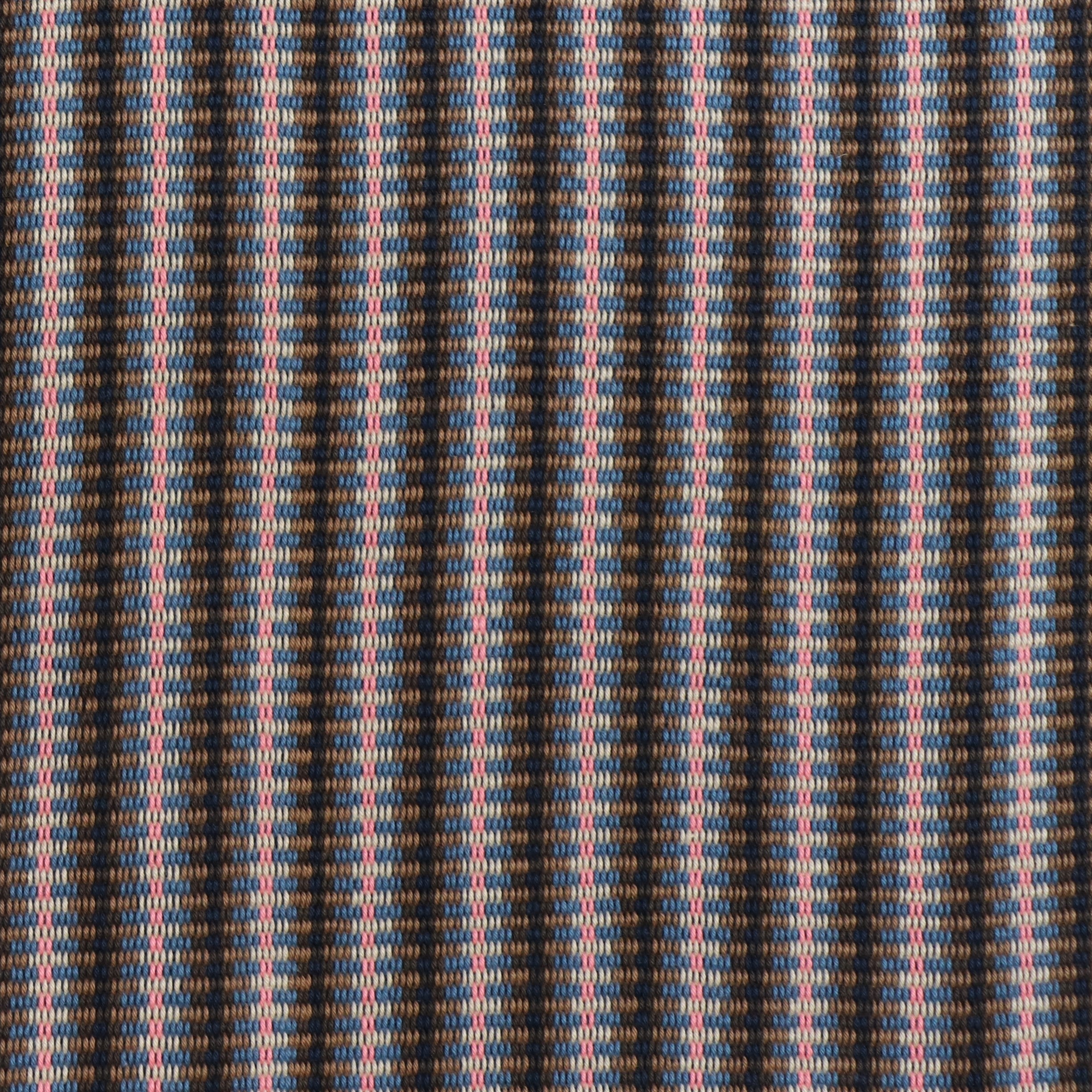 Detail of a hand-woven cotton fabric in an intricate stripe pattern in shades of brown, navy, pink and white.