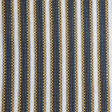 Detail of a hand-woven cotton fabric in an intricate stripe pattern in shades of blue, brown, yellow and white.