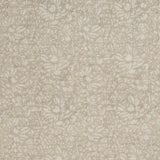 Detail of a printed linen fabric in a repeating chrysanthemum pattern in white on a cream field.