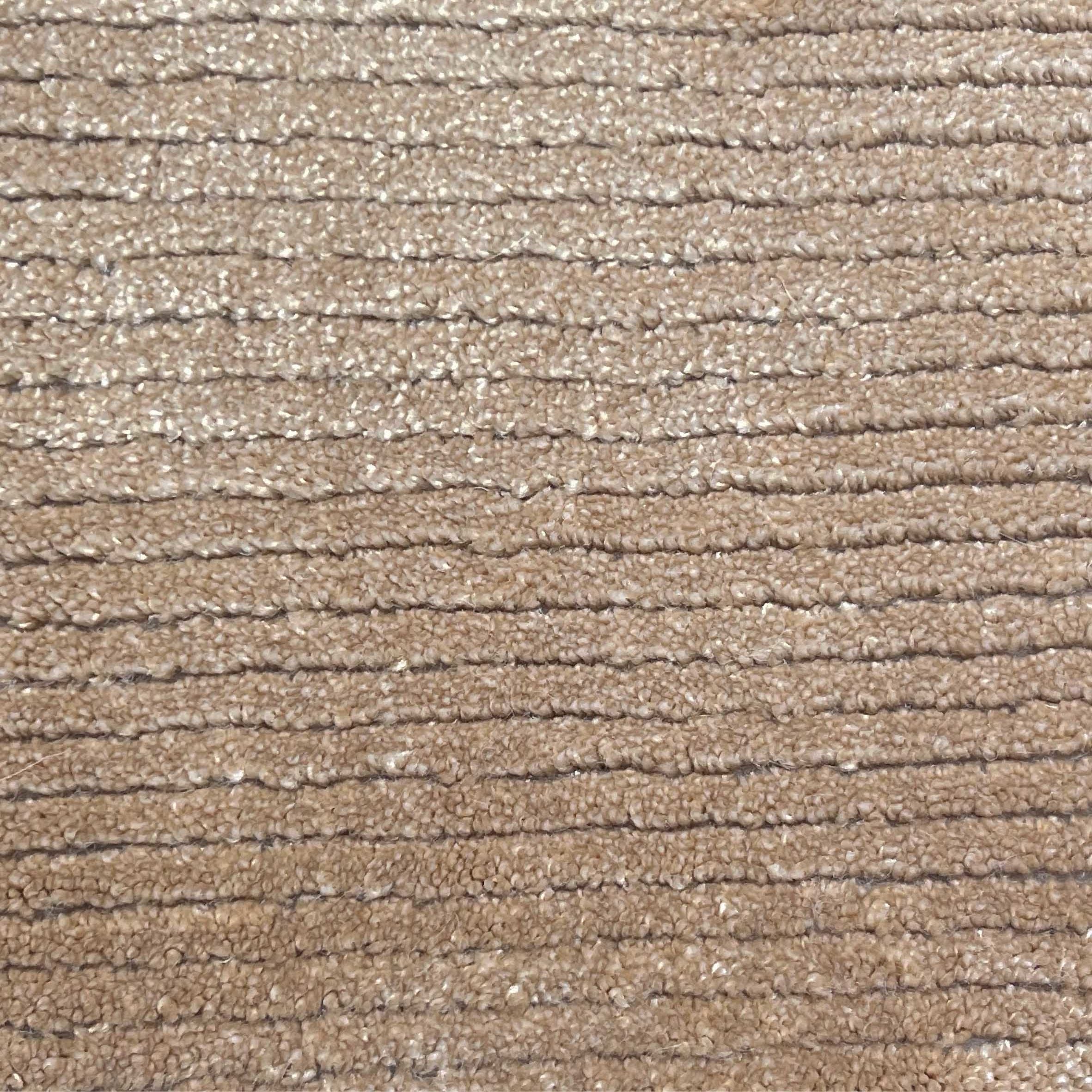 Broadloom carpet in a lightly ribbed cut pile in warm beige. 