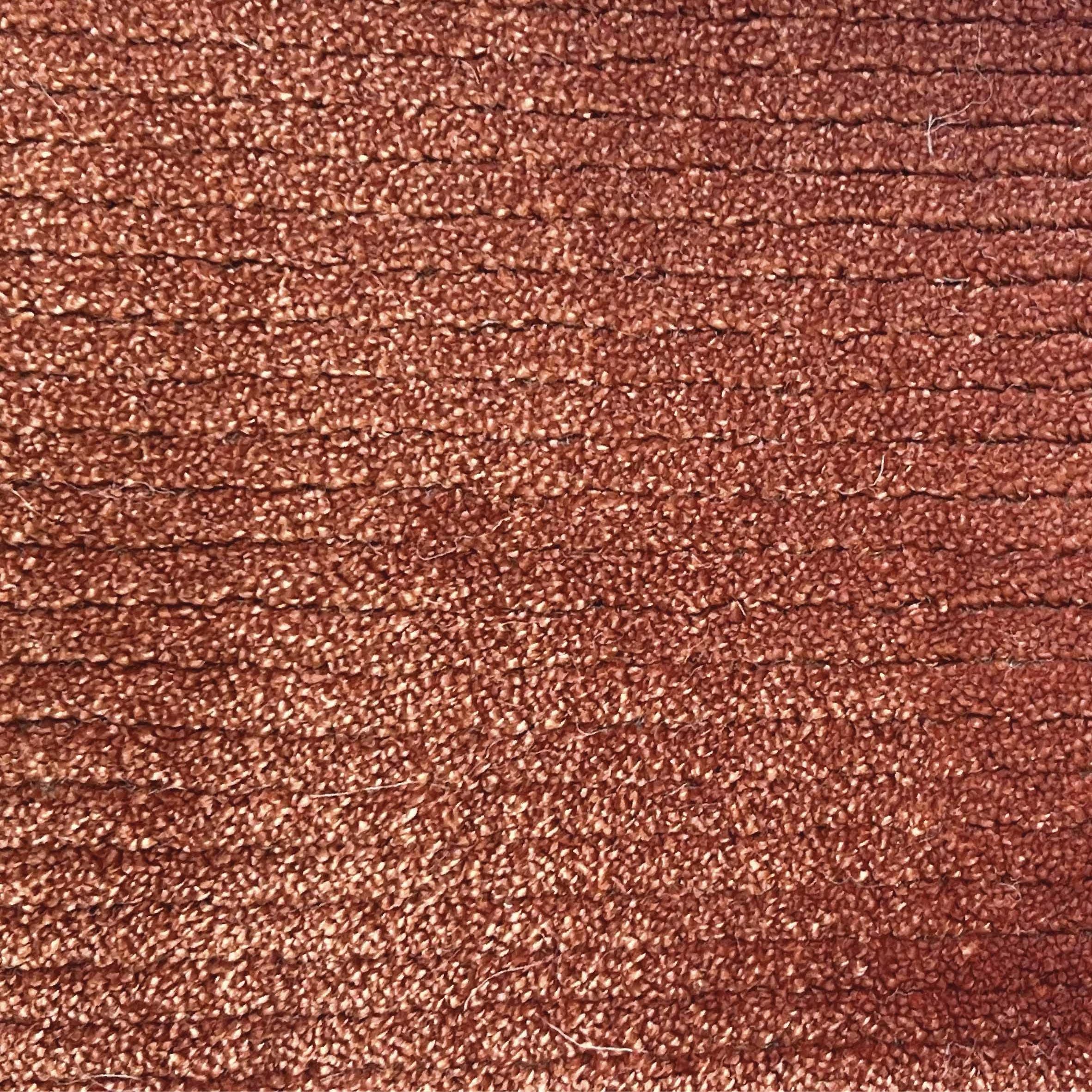 Broadloom carpet in a lightly ribbed cut pile in rust red. 
