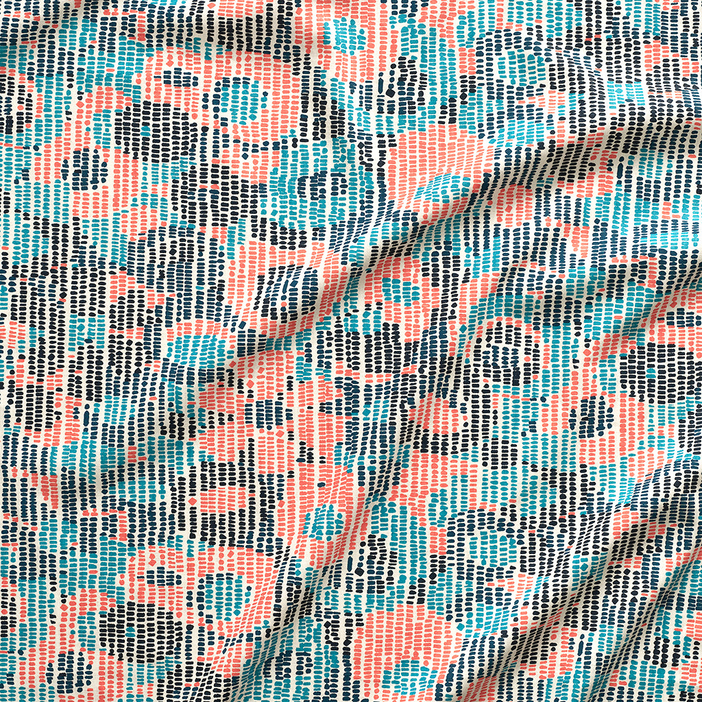 A close up of gently draped printed fabric with a pointillist abstract floral pattern in turquoise, navy blue and coral orange on white. 