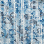 Close up of wallpaper with a pointillist abstract floral pattern in shades of blue on white. 