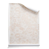 A roll of wallpaper with a pointillist abstract floral pattern in shades of beige on white. 