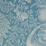 Decorative fabric with a botanical and animal pattern in shades of blue.