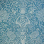 Decorative fabric with classical design elements on a blue background