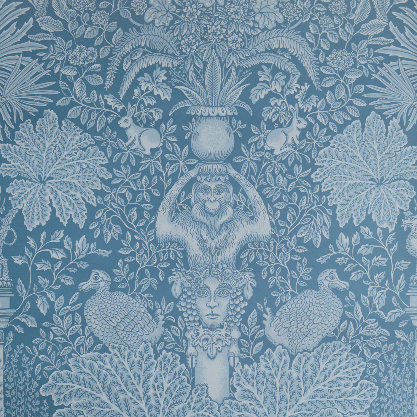 Decorative wallpaper with classical design elements on a blue background