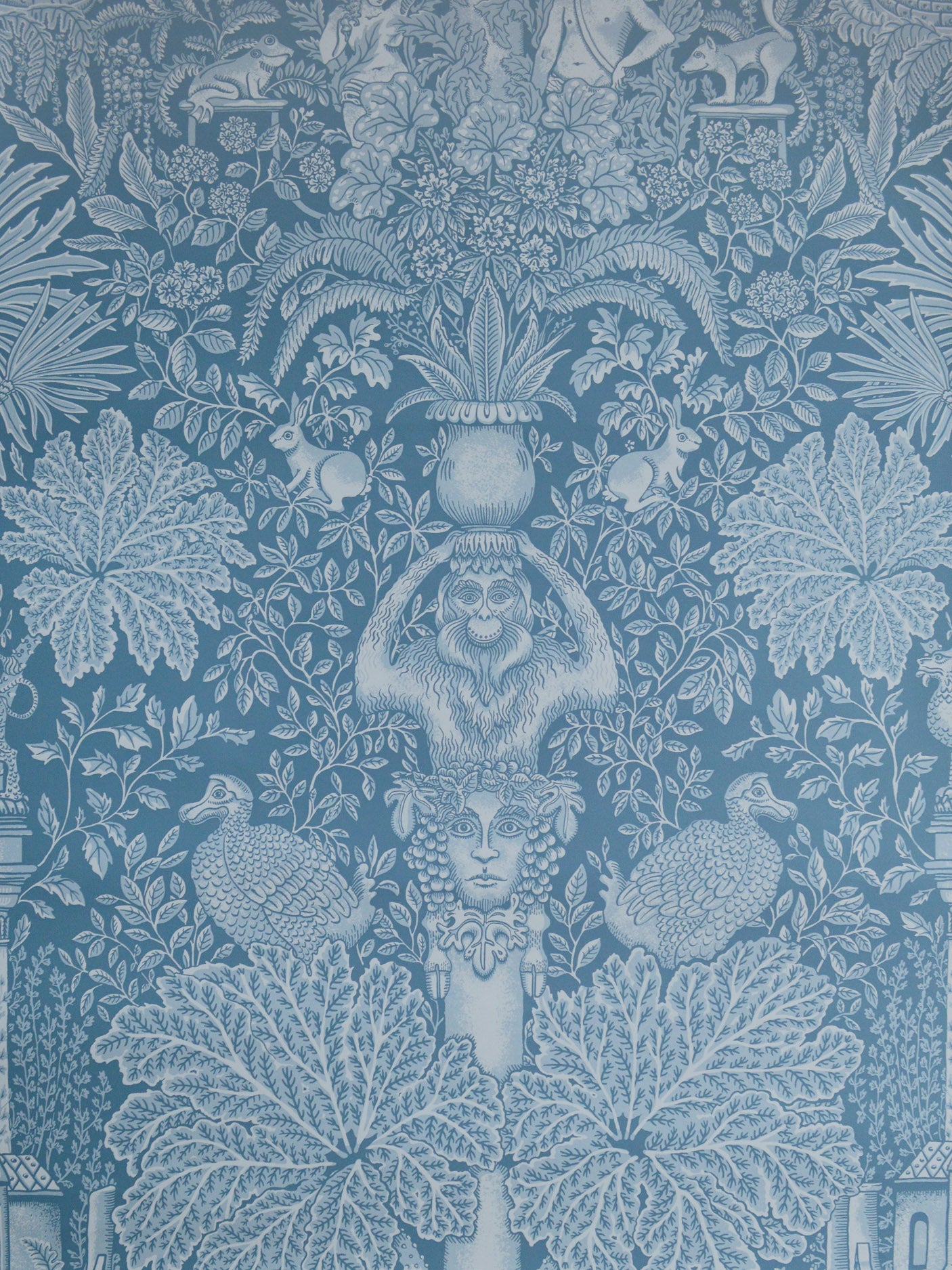 Decorative wallpaper with classical design elements on a blue background