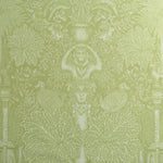 Decorative fabric with classical elements and foliage on a green background