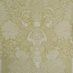 Decorative wallpaper with intricate patterns of leaves, flowers, and classical elements on a green background.