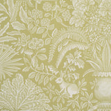 Patterned fabric with white leaves, flowers, and a rabbit on a green background