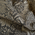 Floral and leaf patterned fabric with a dark background