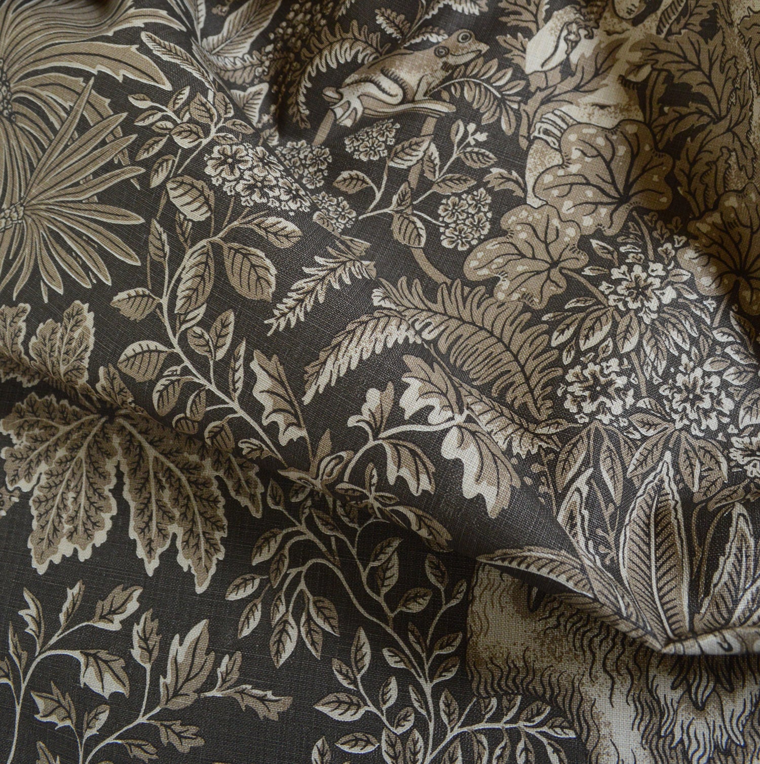 Floral and leaf patterned fabric with a dark background