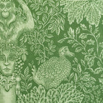 Decorative fabric pattern with classical figures, leaves, and a bird on a green background