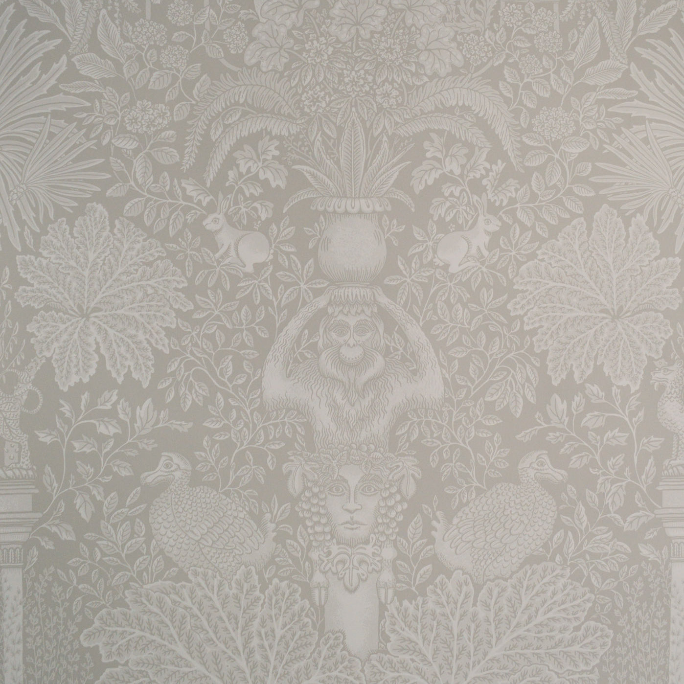 Decorative wallpaper with intricate floral and leaf patterns in a neutral color.