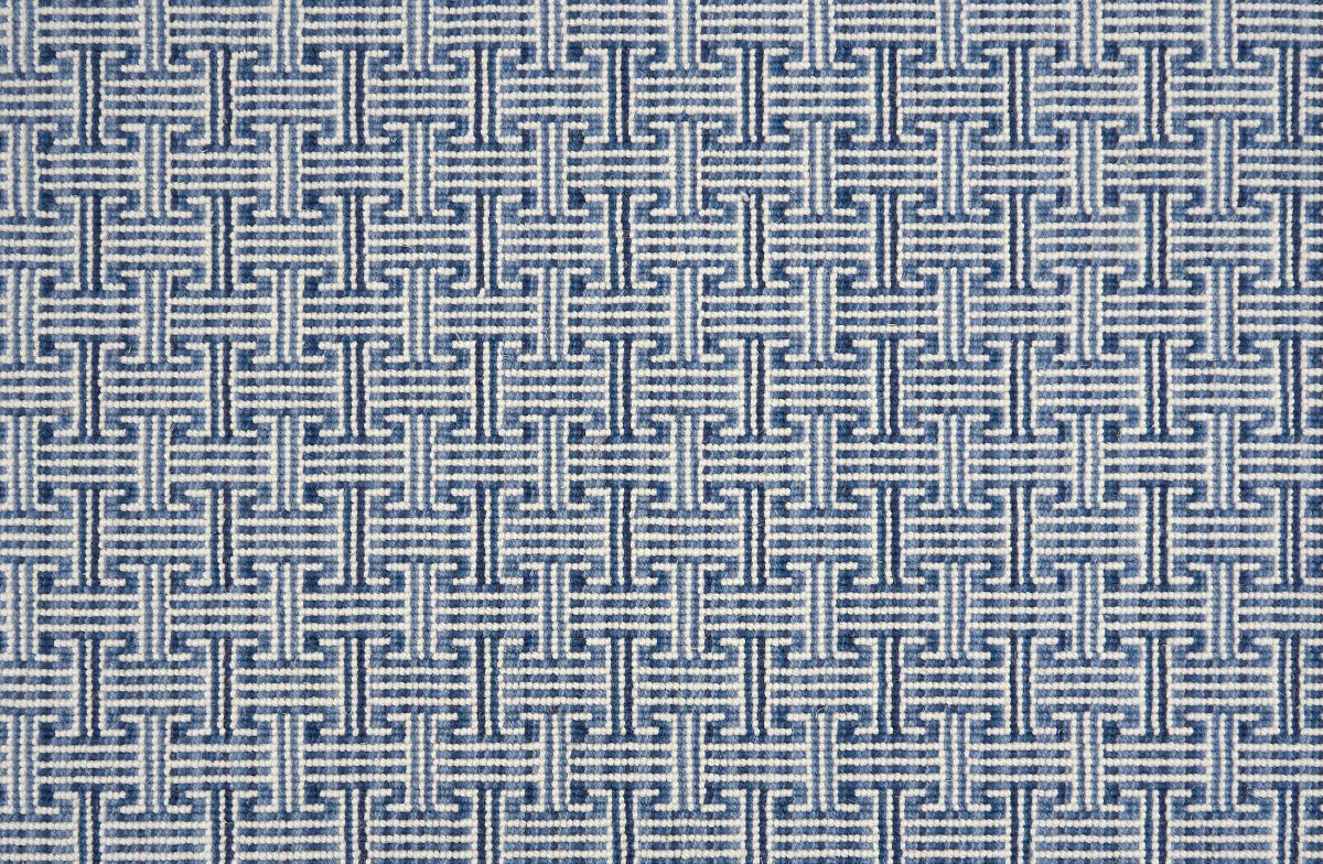 Patterned carpet with a geometric design in blue and white