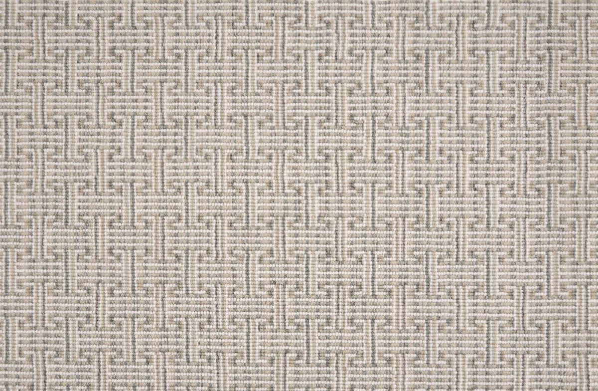 Patterned carpet with a geometric design in beige and white
