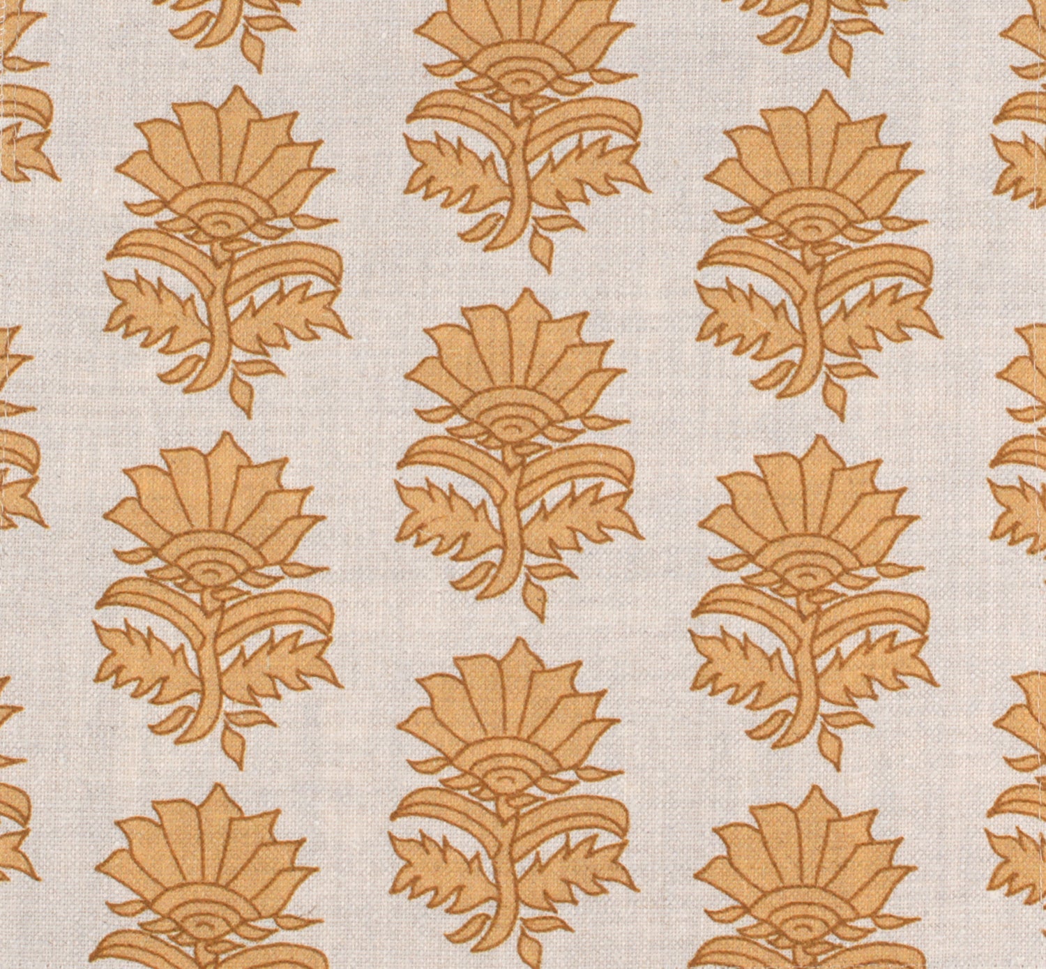Detail of fabric in a repeating thistle print in orange and rust on a cream field.