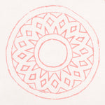 Detail of fabric in a repeating circular geometric print in pink on a white field.