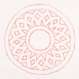 Detail of fabric in a repeating circular geometric print in pink on a white field.