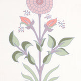 Detail of fabric in a large-scale marigold print in pink, purple and green on a white field.