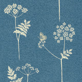 Detail of fabric in a playful flower and butterfly print in cream on a blue field.