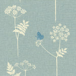 Detail of fabric in a playful flower and butterfly print in cream and blue on a light blue field.