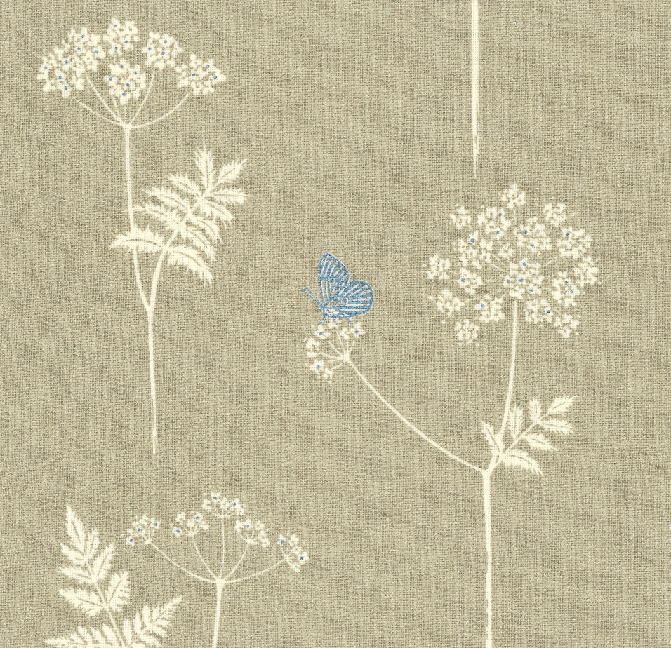 Detail of fabric in a playful flower and butterfly print in cream and blue on a tan field.