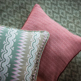 Two patterned cushions on a textured surface