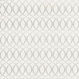 Detail of fabric in a playful floral lattice print in yellow and navy on a cream field.