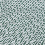 Detail of a wallpaper panel in a painterly herringbone print in olive on a light blue field.