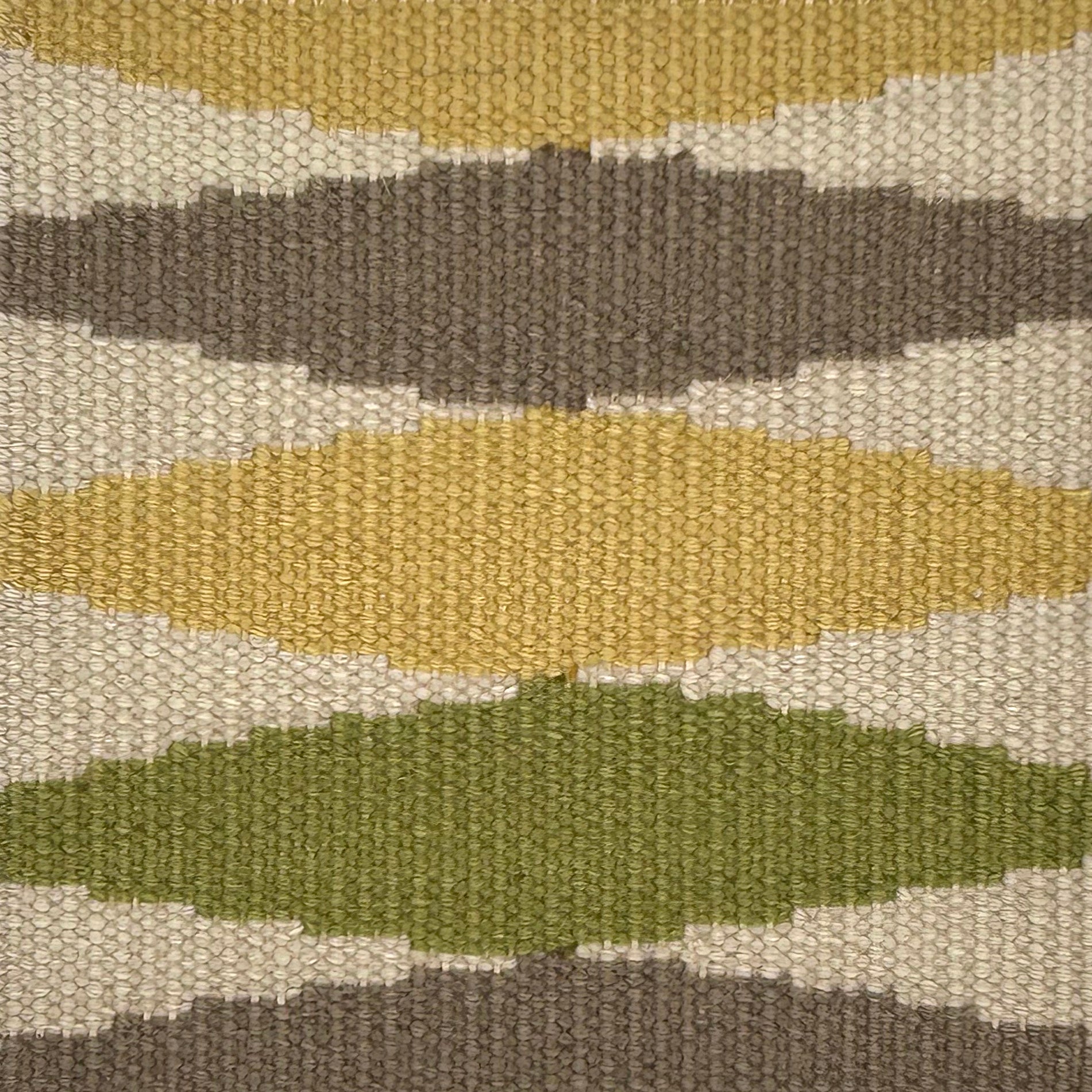 Flatweave carpet with diamonds in yellow. brown, green and cream. 