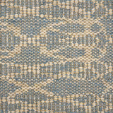 Handwoven rug detail in a geometric design in slate and beige