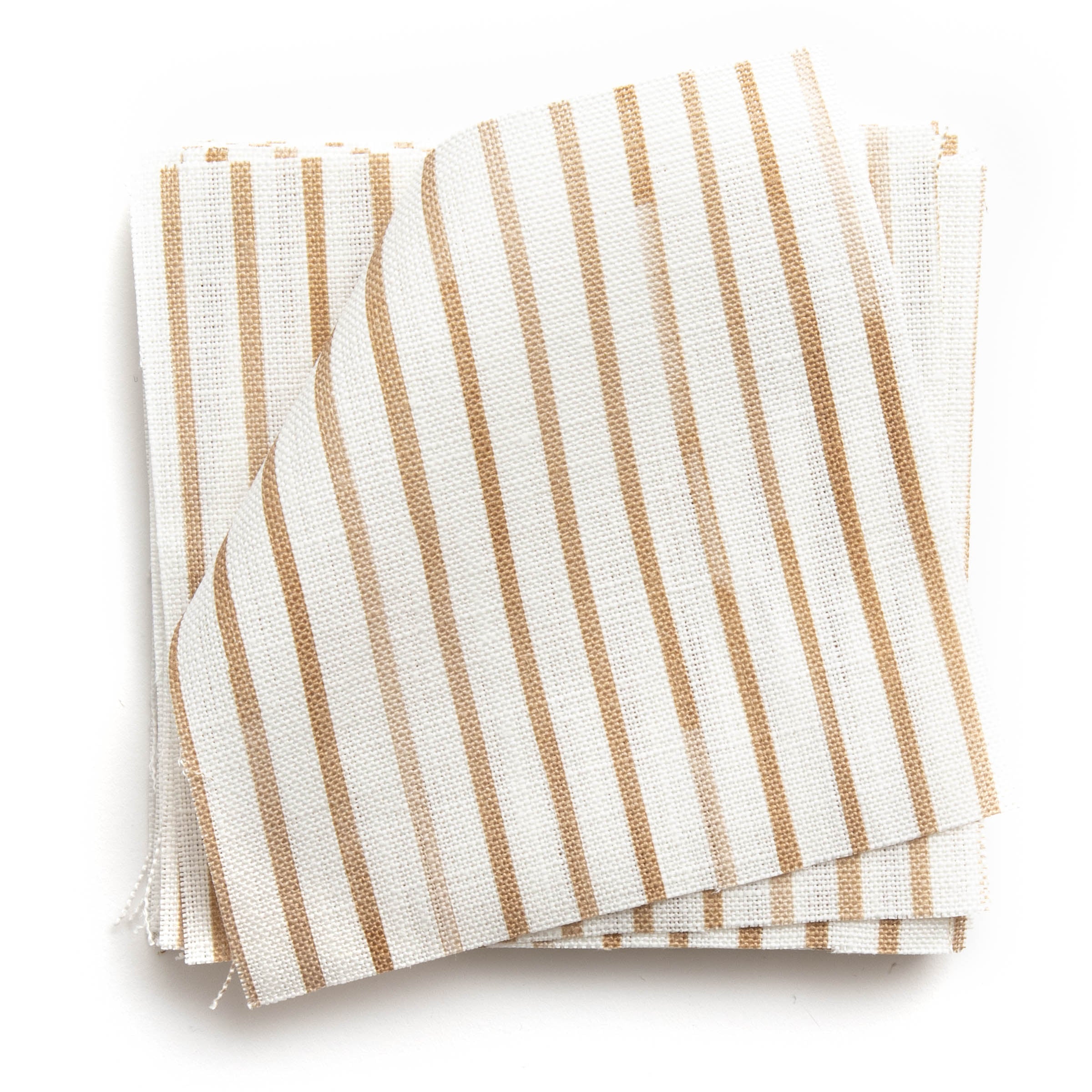 A stack of fabric swatches in a painterly stripe pattern in bronze on a white field.