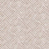 Detail of fabric in a painterly grid pattern in brown on a white field.