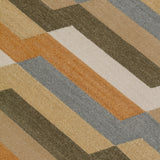 Detail of a handwoven rug with a stacked zig zag stripe in shades of tan, ochre, chambray blue and ivory. 