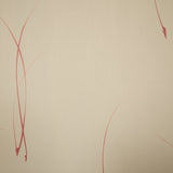 Detail of a wallpaper in an elongated paint splatter pattern in metallic navy on a rust field.