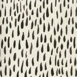 Fabric in a painterly dabbed print in charcoal on a cream field.