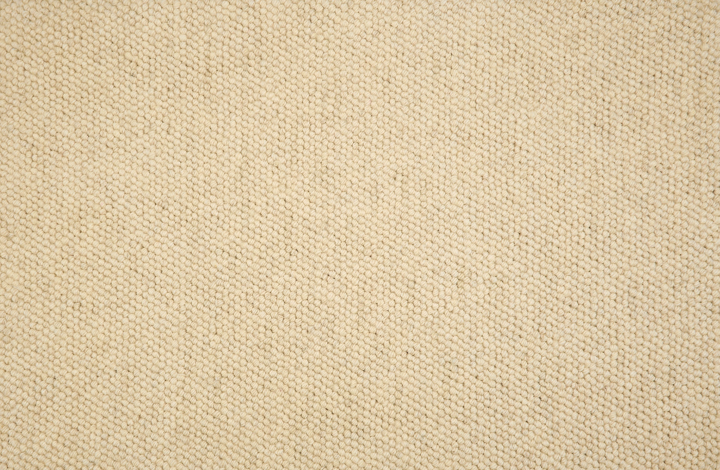Close-up of loop broadloom carpet in cream.