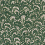 Detail of fabric in a marbled paint print in shades of green and cream.