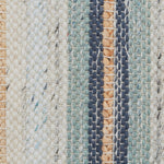 Close-up of a broadloom carpet fabric with stripes in teal, navy, beige and tan. 