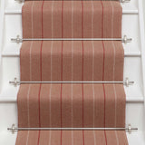 Striped flatweave runner in red and sand on white staircase