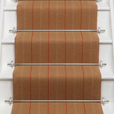 Striped flatweave runner in orange on white staircase