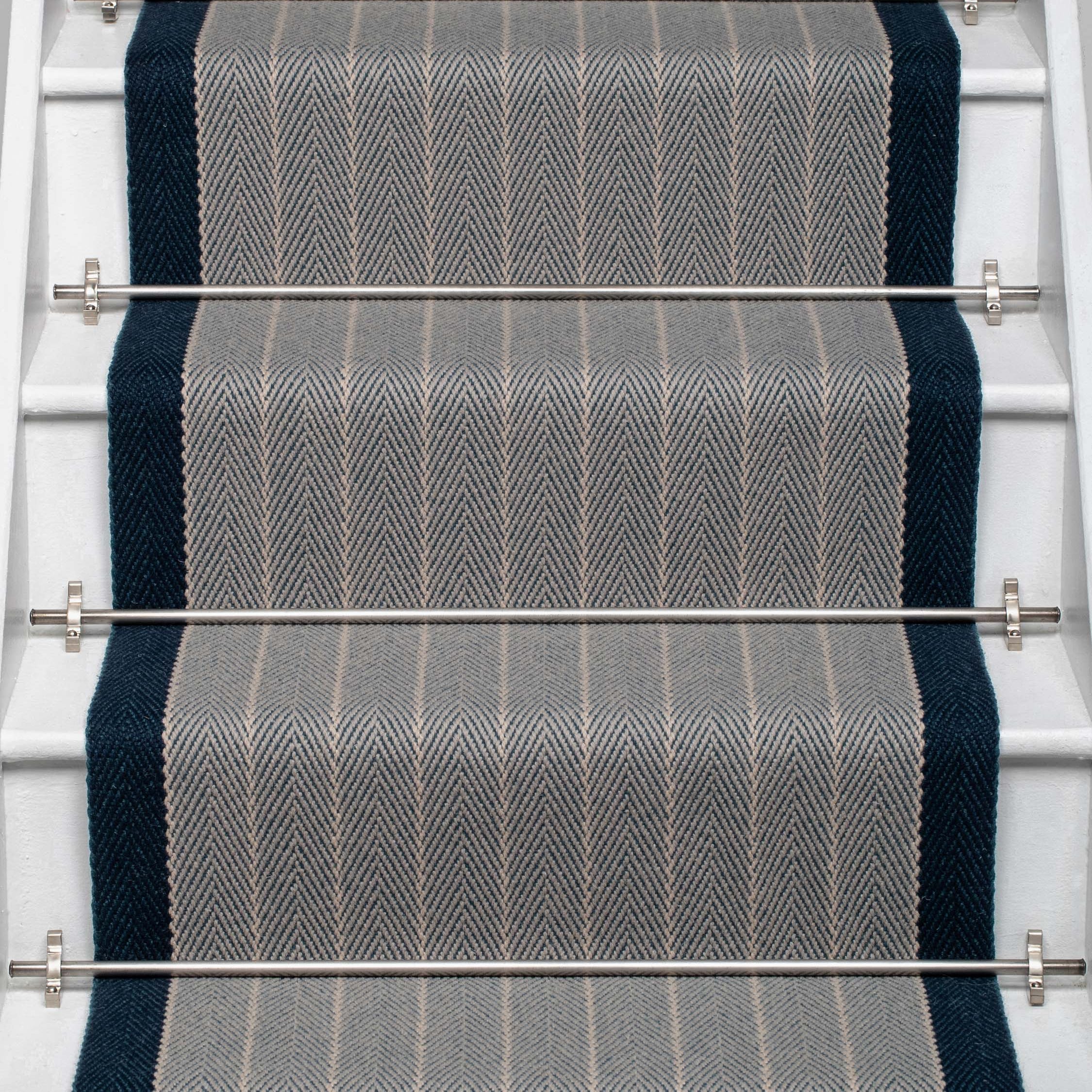Striped flatweave runner in grey and dark blue on white staircase