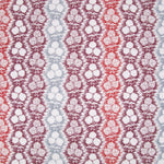 Fabric in a detailed botanical stripe print in shades of blue, red and purple on a white field.